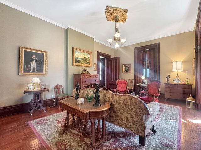 59 S Chillicothe St, South Charleston, OH 45368 - living area with an inviting chandelier, ornamental molding, hardwood / wood-style floors, and baseboards