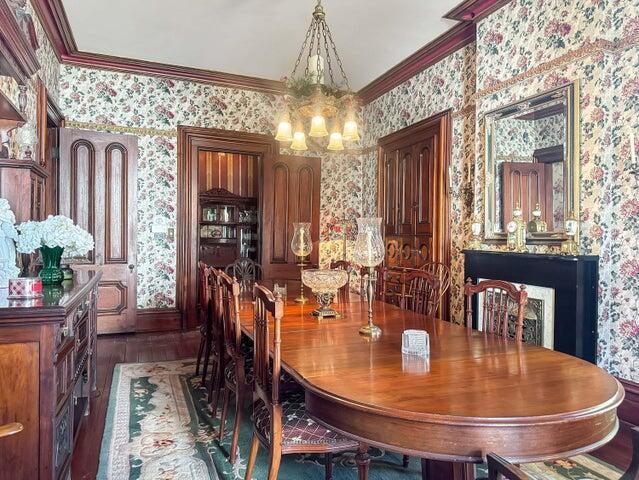 59 S Chillicothe St, South Charleston, OH 45368 - dining room with wallpapered walls, ornamental molding, and an inviting chandelier