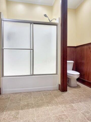 59 S Chillicothe St, South Charleston, OH 45368 - bathroom with shower / bath combination with glass door, toilet, and a wainscoted wall