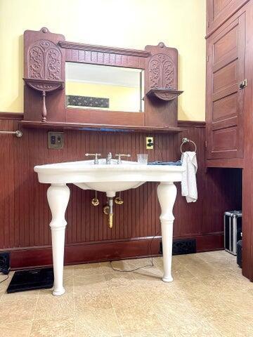 59 S Chillicothe St, South Charleston, OH 45368 - bathroom featuring tile patterned floors, wood walls, and wainscoting