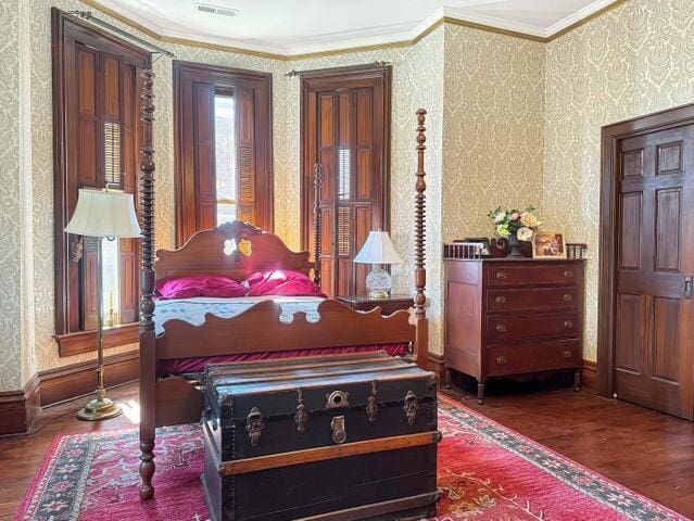 59 S Chillicothe St, South Charleston, OH 45368 - bedroom featuring ornamental molding, wood finished floors, wallpapered walls, and visible vents