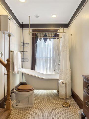 59 S Chillicothe St, South Charleston, OH 45368 - bathroom with vanity, baseboards, a soaking tub, and curtained shower