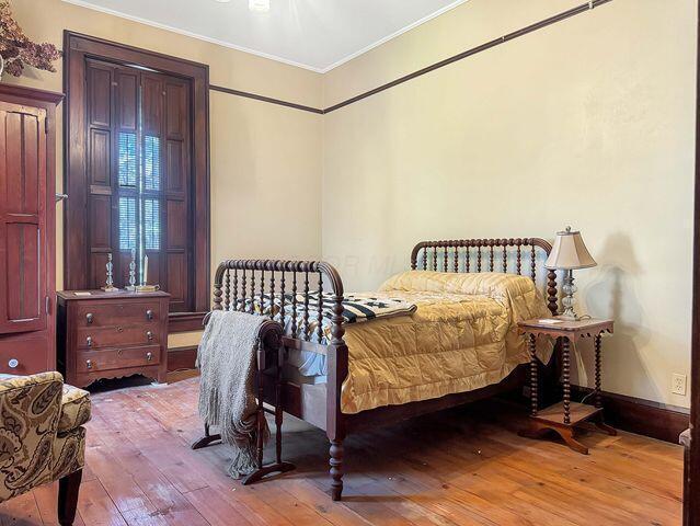 59 S Chillicothe St, South Charleston, OH 45368 - bedroom featuring crown molding and hardwood / wood-style floors