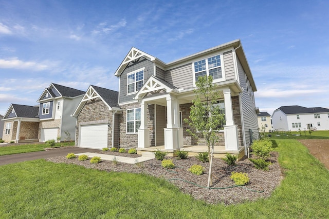 121 E Wind Rd, Delaware, OH 43015 - craftsman-style home featuring covered porch, stone siding, aphalt driveway, and a front lawn