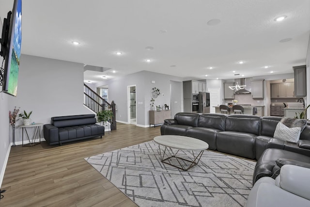 121 E Wind Rd, Delaware, OH 43015 - living area with baseboards, light wood-style floors, recessed lighting, and stairway