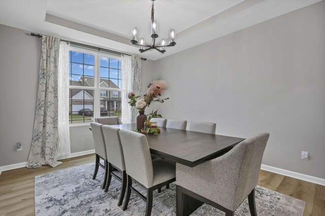 121 E Wind Rd, Delaware, OH 43015 - dining room featuring wood finished floors, baseboards, and a notable chandelier