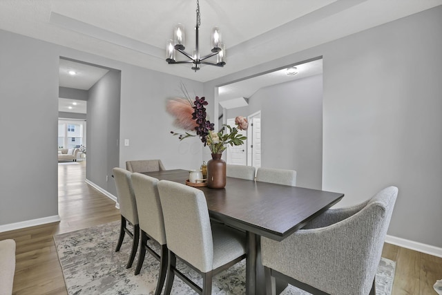 121 E Wind Rd, Delaware, OH 43015 - dining space featuring light wood-type flooring, baseboards, and a notable chandelier