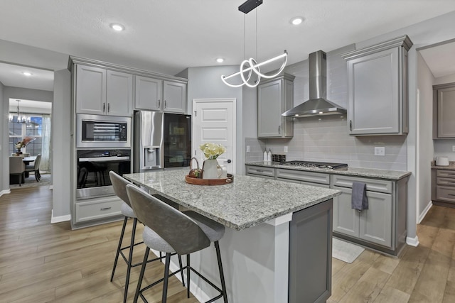121 E Wind Rd, Delaware, OH 43015 - kitchen featuring appliances with stainless steel finishes, gray cabinets, and wall chimney exhaust hood