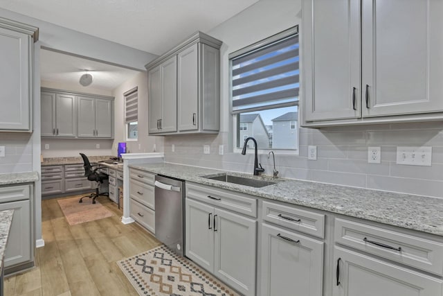 121 E Wind Rd, Delaware, OH 43015 - kitchen featuring a sink, built in desk, tasteful backsplash, dishwasher, and light wood finished floors