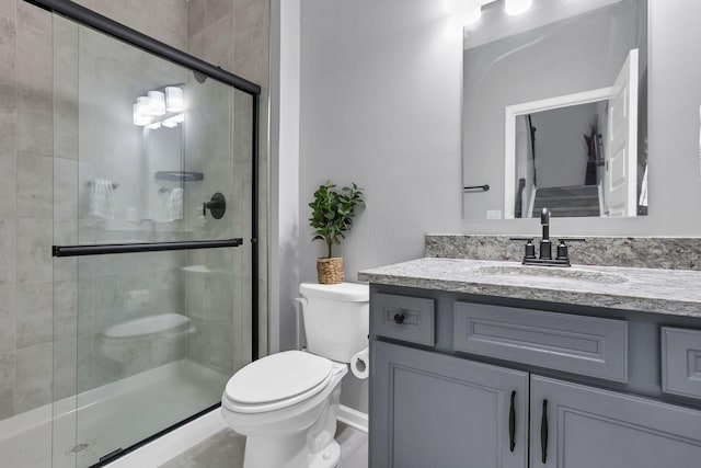 121 E Wind Rd, Delaware, OH 43015 - bathroom featuring vanity, toilet, baseboards, and a stall shower