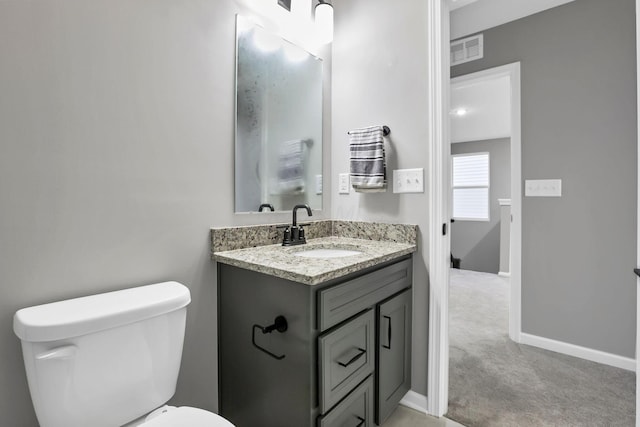 121 E Wind Rd, Delaware, OH 43015 - half bath with toilet, baseboards, vanity, and visible vents