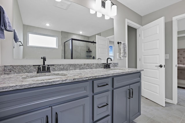 121 E Wind Rd, Delaware, OH 43015 - bathroom featuring a sink, double vanity, a stall shower, and tile patterned floors