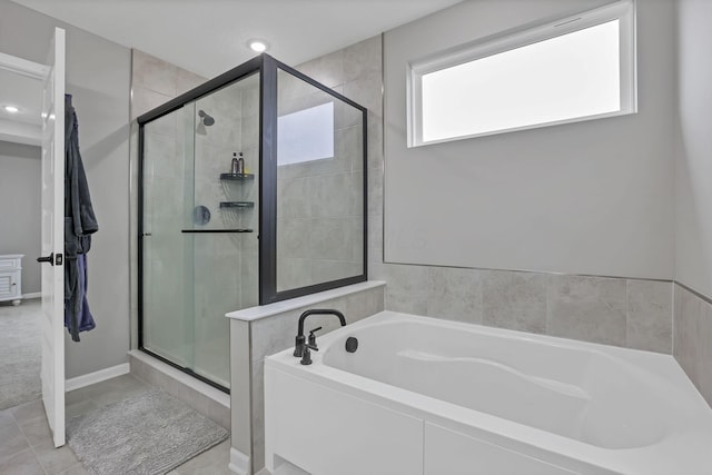 121 E Wind Rd, Delaware, OH 43015 - bathroom featuring a stall shower, tile patterned flooring, and a garden tub