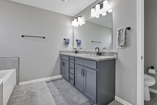 121 E Wind Rd, Delaware, OH 43015 - bathroom with a sink, double vanity, toilet, and baseboards