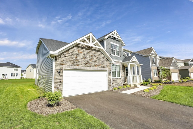 121 E Wind Rd, Delaware, OH 43015 - craftsman-style house featuring driveway, an attached garage, a residential view, stone siding, and a front lawn