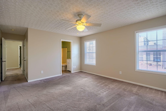 unfurnished bedroom featuring baseboards, carpet flooring, and connected bathroom
