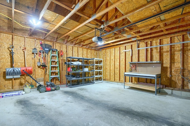 garage with a workshop area and a garage door opener