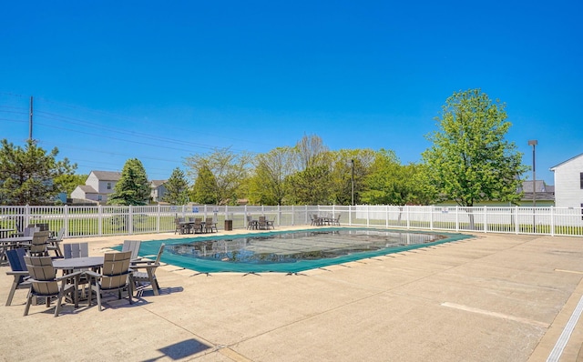view of pool with a patio and fence