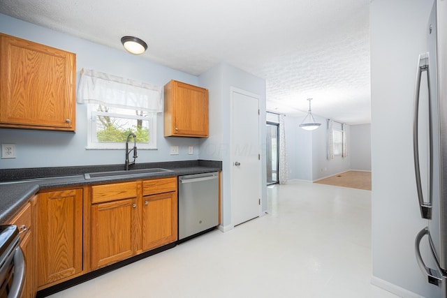1418 Brookforest Dr, Columbus, OH 43204 - kitchen featuring appliances with stainless steel finishes, a textured ceiling, plenty of natural light, and a sink