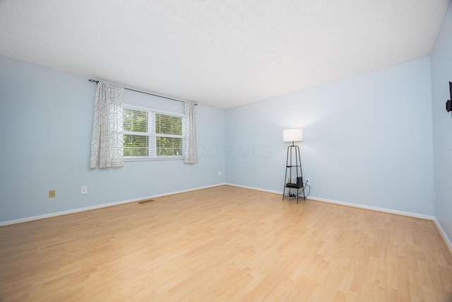 1418 Brookforest Dr, Columbus, OH 43204 - empty room with baseboards, visible vents, and light wood-style floors
