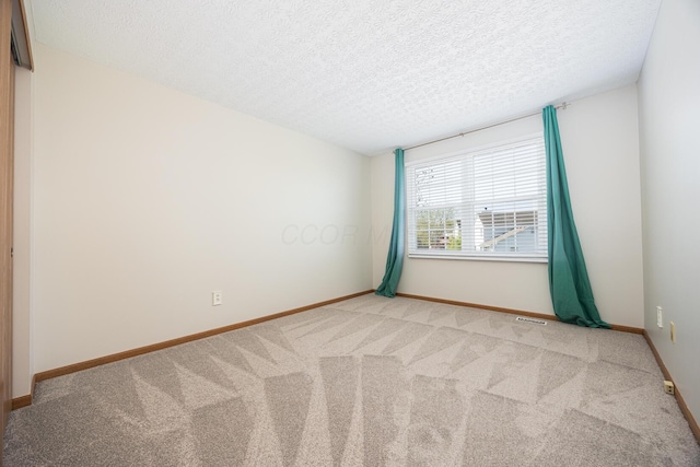 1418 Brookforest Dr, Columbus, OH 43204 - empty room with a textured ceiling, baseboards, and carpet floors