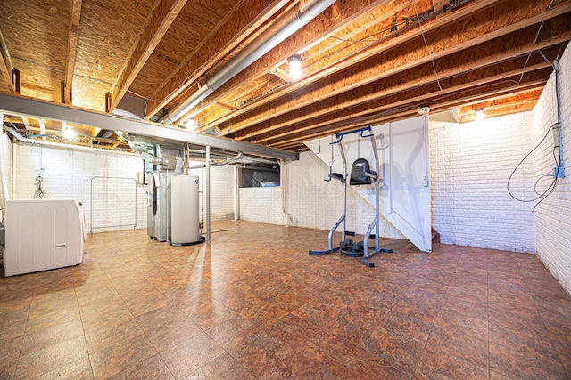 1418 Brookforest Dr, Columbus, OH 43204 - unfinished below grade area featuring gas water heater, independent washer and dryer, and brick wall