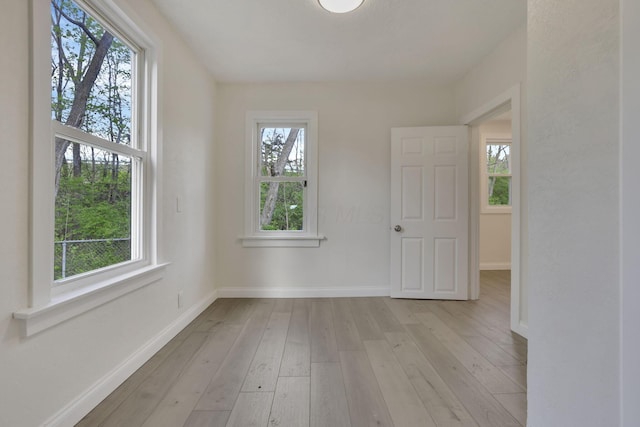 empty room featuring light wood-style flooring and baseboards