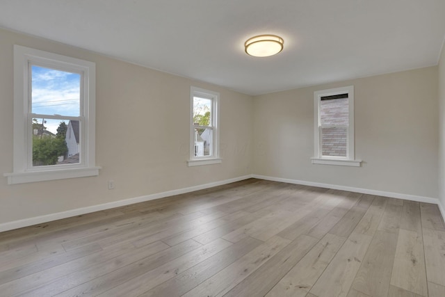 unfurnished room featuring baseboards and hardwood / wood-style flooring