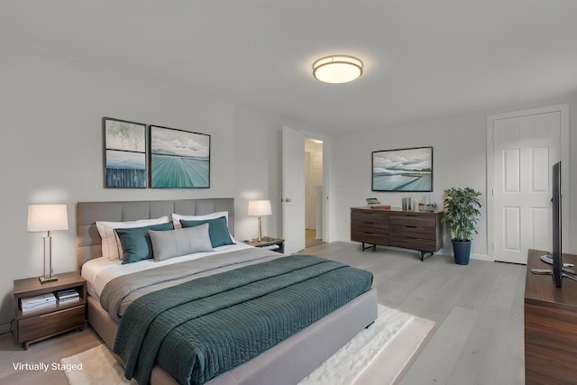 bedroom featuring wood finished floors and baseboards