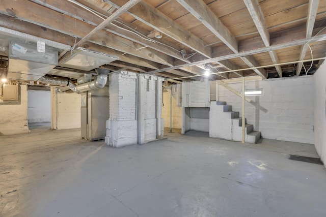 unfinished below grade area with stairs and heating unit