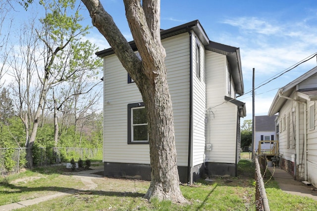 view of home's exterior with fence