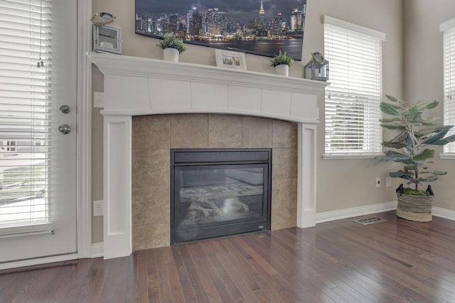 3884 Winding Oaks Dr, Columbus, OH 43228 - details with visible vents, baseboards, wood finished floors, and a tile fireplace