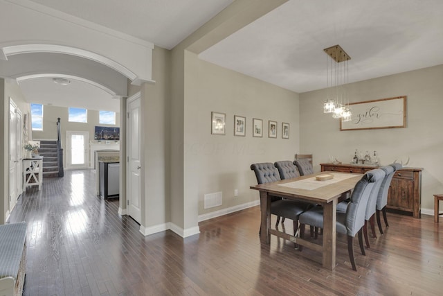 3884 Winding Oaks Dr, Columbus, OH 43228 - dining room featuring visible vents, dark wood-style flooring, a fireplace, baseboards, and a chandelier