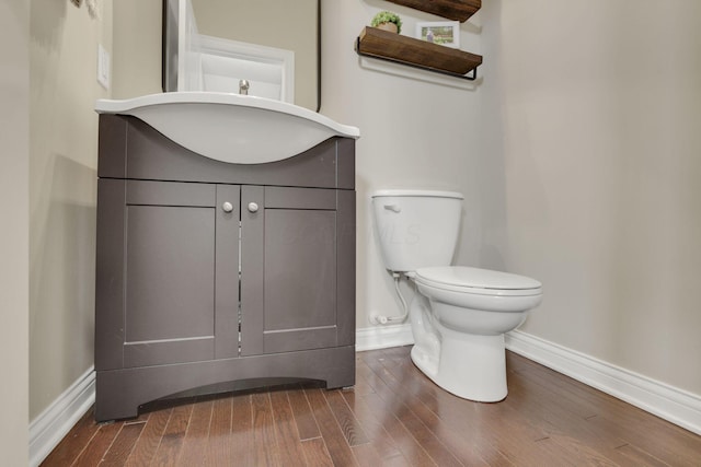 3884 Winding Oaks Dr, Columbus, OH 43228 - bathroom with toilet, baseboards, wood finished floors, and vanity
