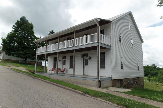multi unit property featuring covered porch and a balcony