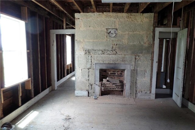 unfurnished living room with a stone fireplace