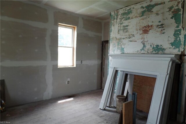 unfurnished room featuring wood-type flooring