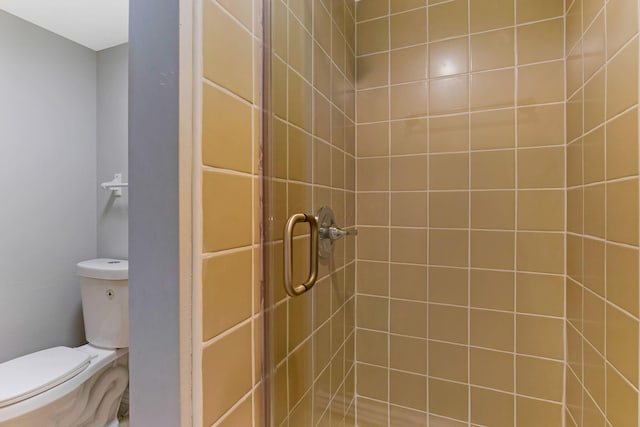 full bath with toilet and a stall shower