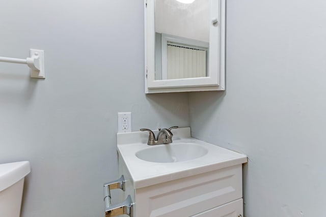 half bathroom featuring toilet and vanity