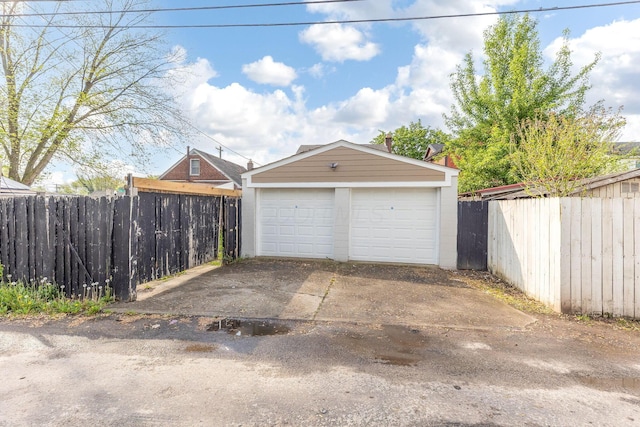 detached garage featuring fence
