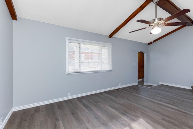 empty room featuring arched walkways, a ceiling fan, dark wood finished floors, and vaulted ceiling with beams