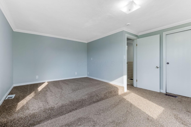 unfurnished bedroom with carpet floors, crown molding, and baseboards