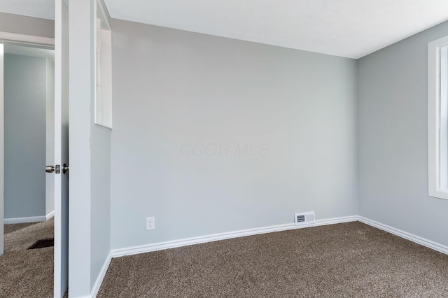 carpeted empty room with baseboards and visible vents