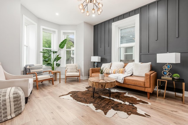 sitting room featuring baseboards, recessed lighting, light wood-style flooring, and a notable chandelier