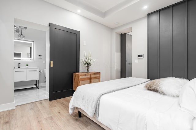 bedroom with recessed lighting, baseboards, and light wood finished floors