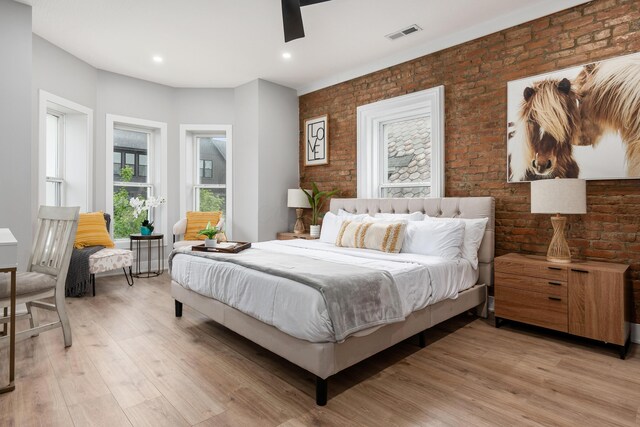 bedroom with visible vents, brick wall, recessed lighting, a ceiling fan, and light wood-style flooring