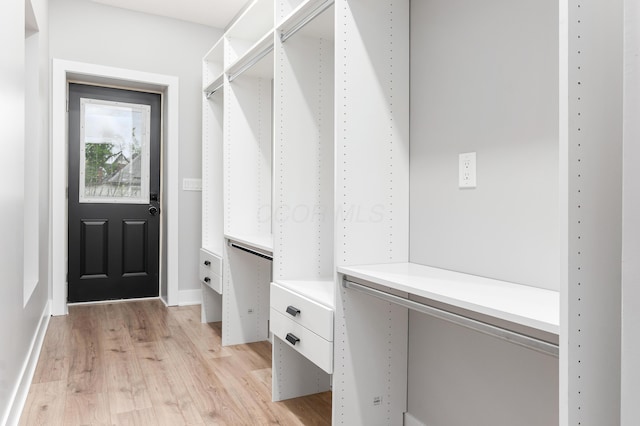 mudroom featuring baseboards and light wood-style floors