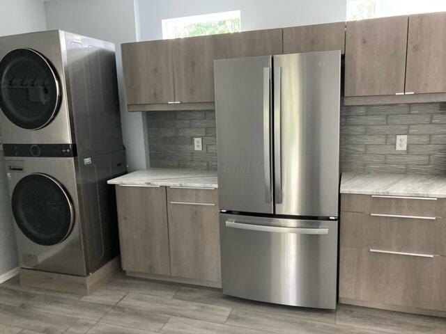 laundry area with laundry area and stacked washer and clothes dryer