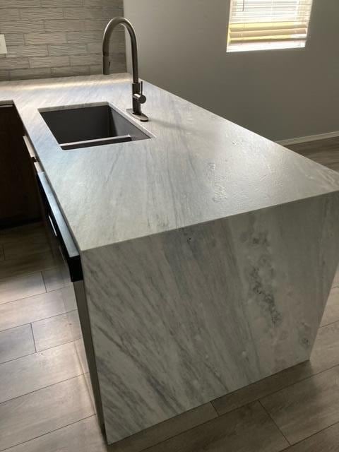 kitchen featuring a sink and light countertops