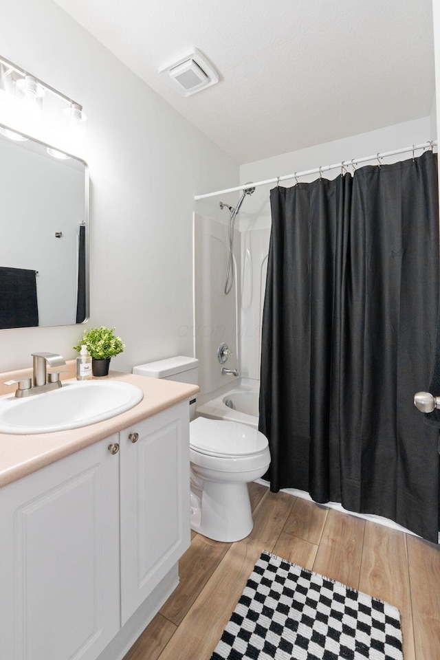 6516 Nottinghill Trail Dr, Canal Winchester, OH 43110 - bathroom with wood finished floors, vanity, visible vents, toilet, and shower / bath combo with shower curtain